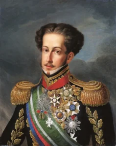 Uma pintura de retrato formal do Imperador Dom Pedro I em uniforme militar de gala completo com dragonas de ouro, faixas e inúmeras medalhas do Brasil Império, contra um fundo escuro e nublado. A imagem é uma representação da figura histórica chave de Dom Pedro I.
